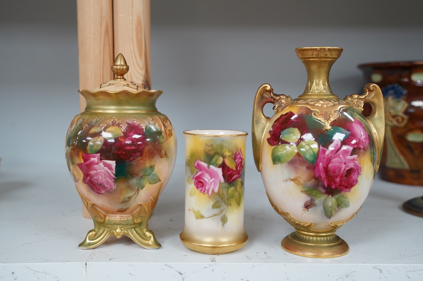 Three Royal Worcester rose painted vases, numbers 1684, 245 and 2510, tallest 18cm. Condition - good